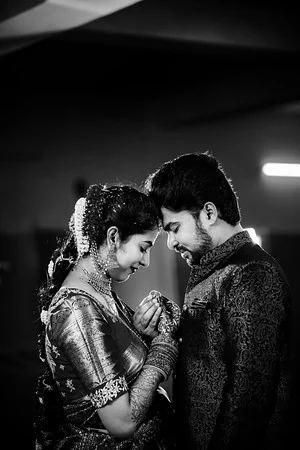 Black and white portrait of a couple resting their foreheads together